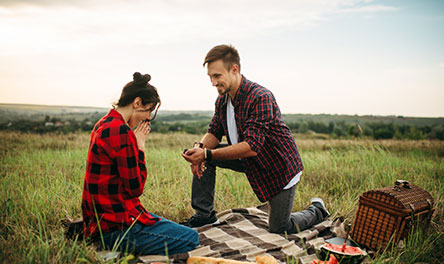 A man and woman embracing sitting next to a lake. God intends relationship and marriage bonds between a man and a woman.